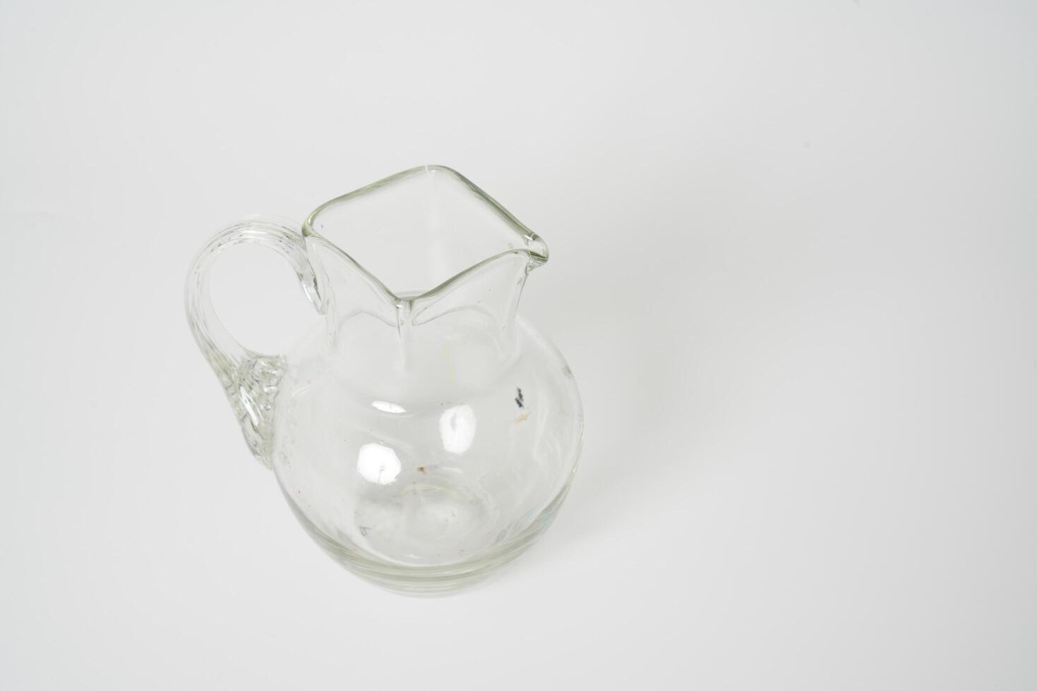 Glass carafe on white background photo