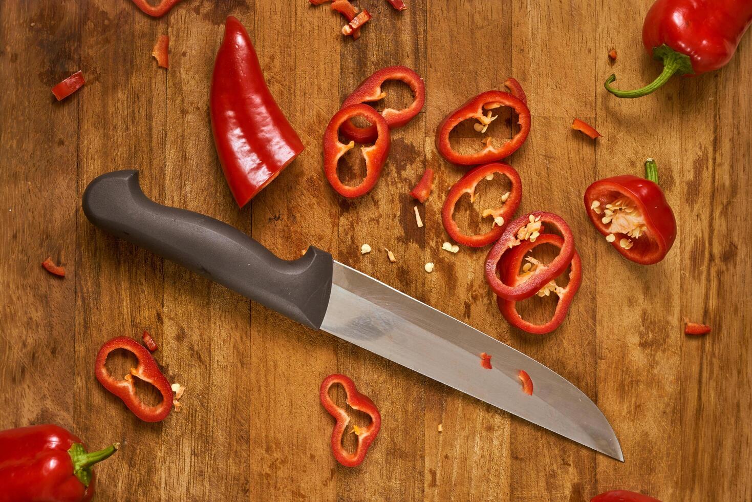Slices of red pepper on a cutting board photo
