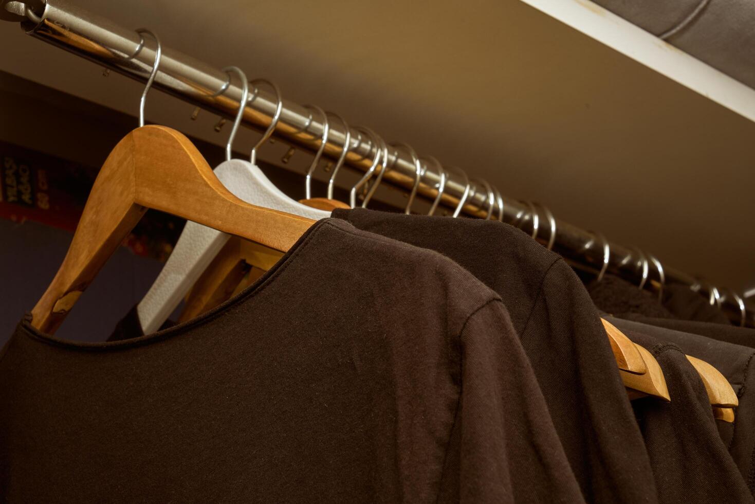 black t-shirts on wooden hangers photo