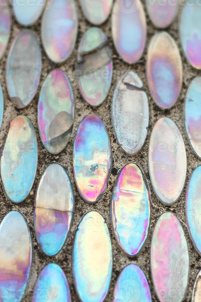 Texture of mother-of-pearl mosaic round tiles, close-up photo