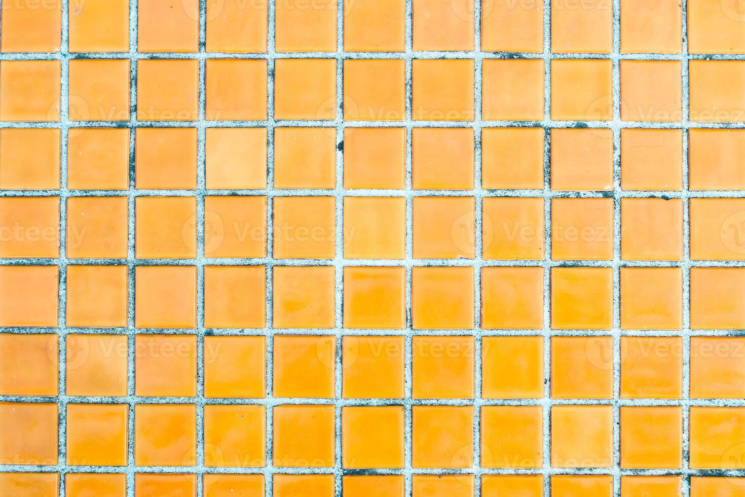 Texture of yellow mosaic tiles, close-up photo