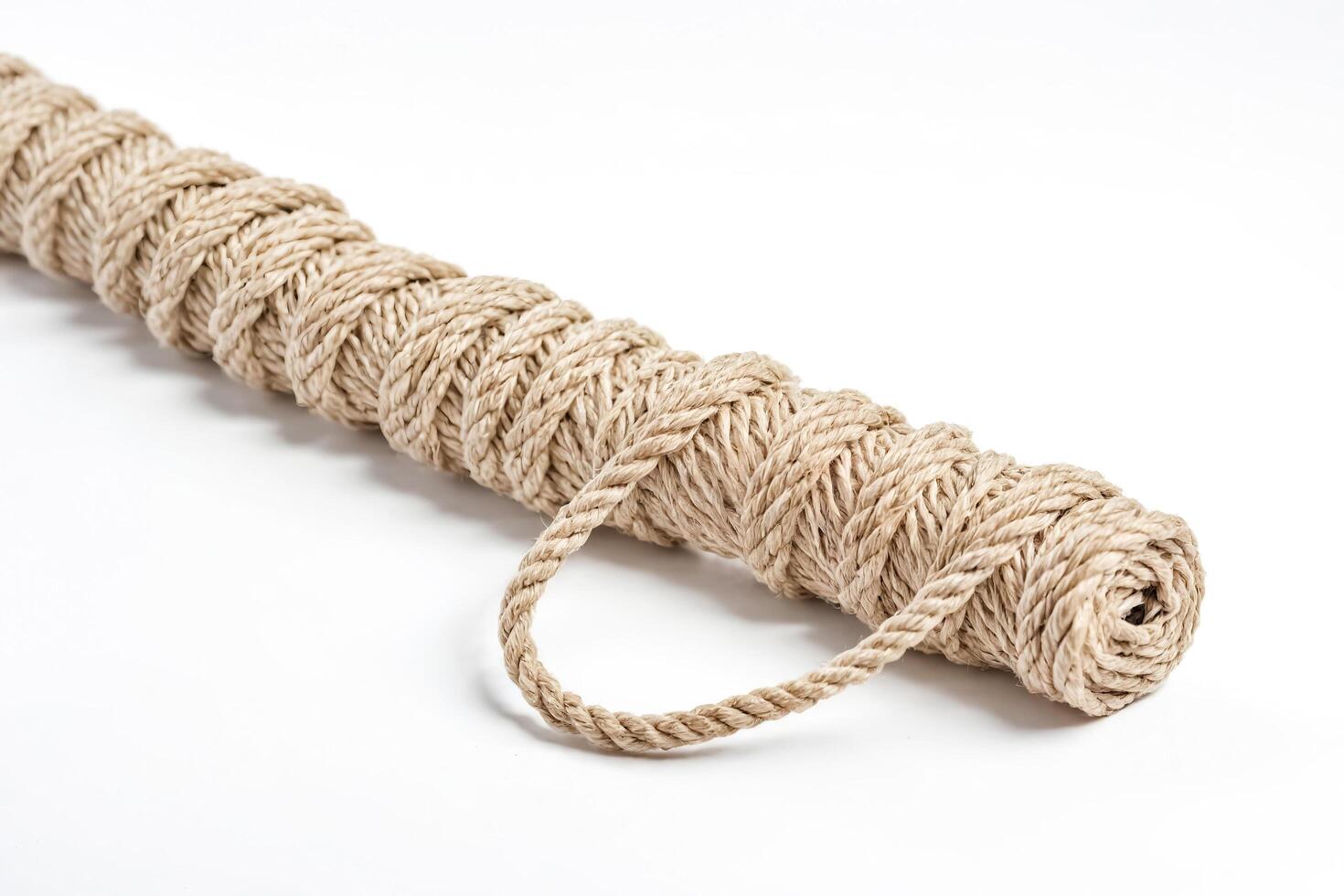 Roll of natural jute rope isolated on white background photo