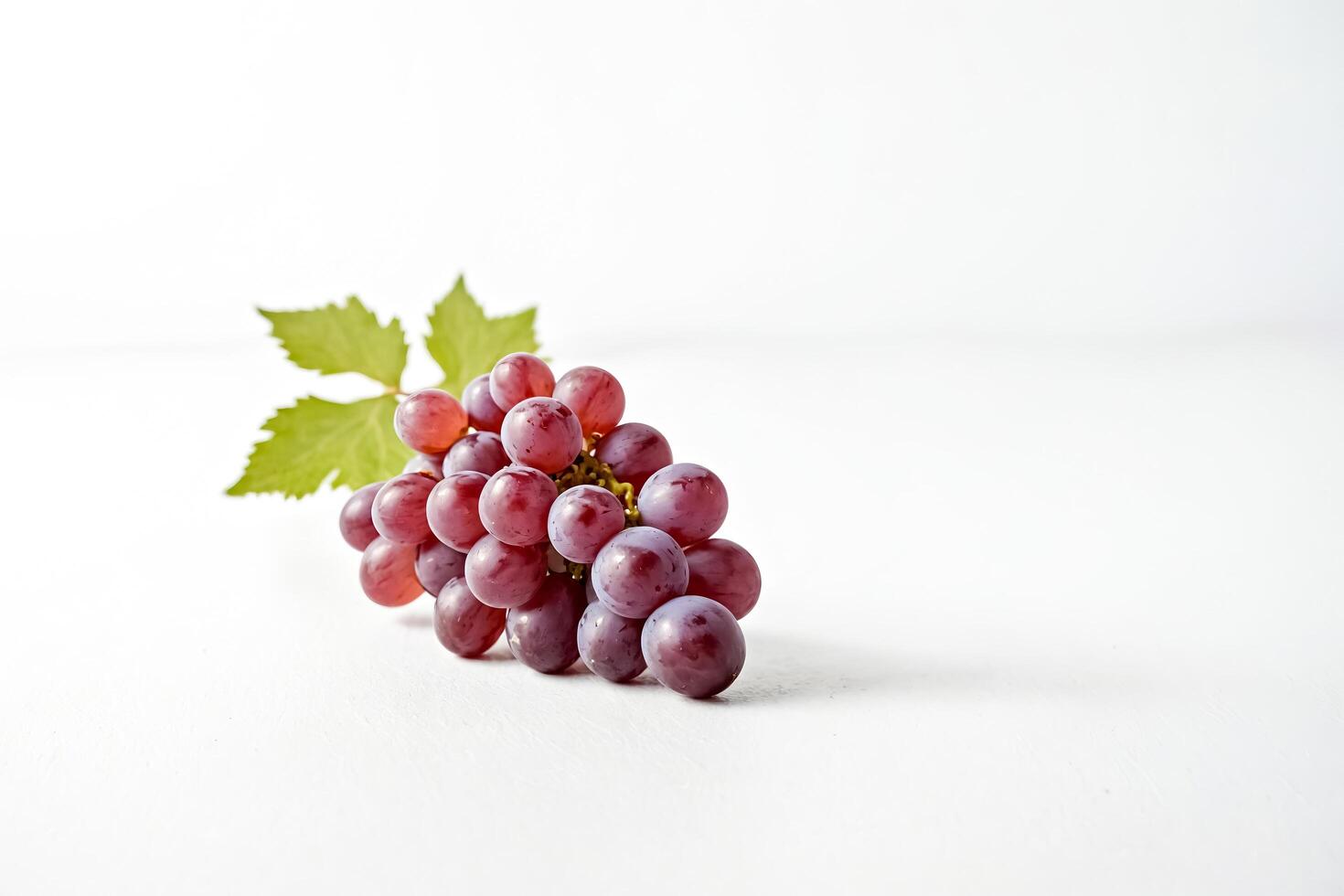 Closeup of a bunch of red grapes on a white background photo