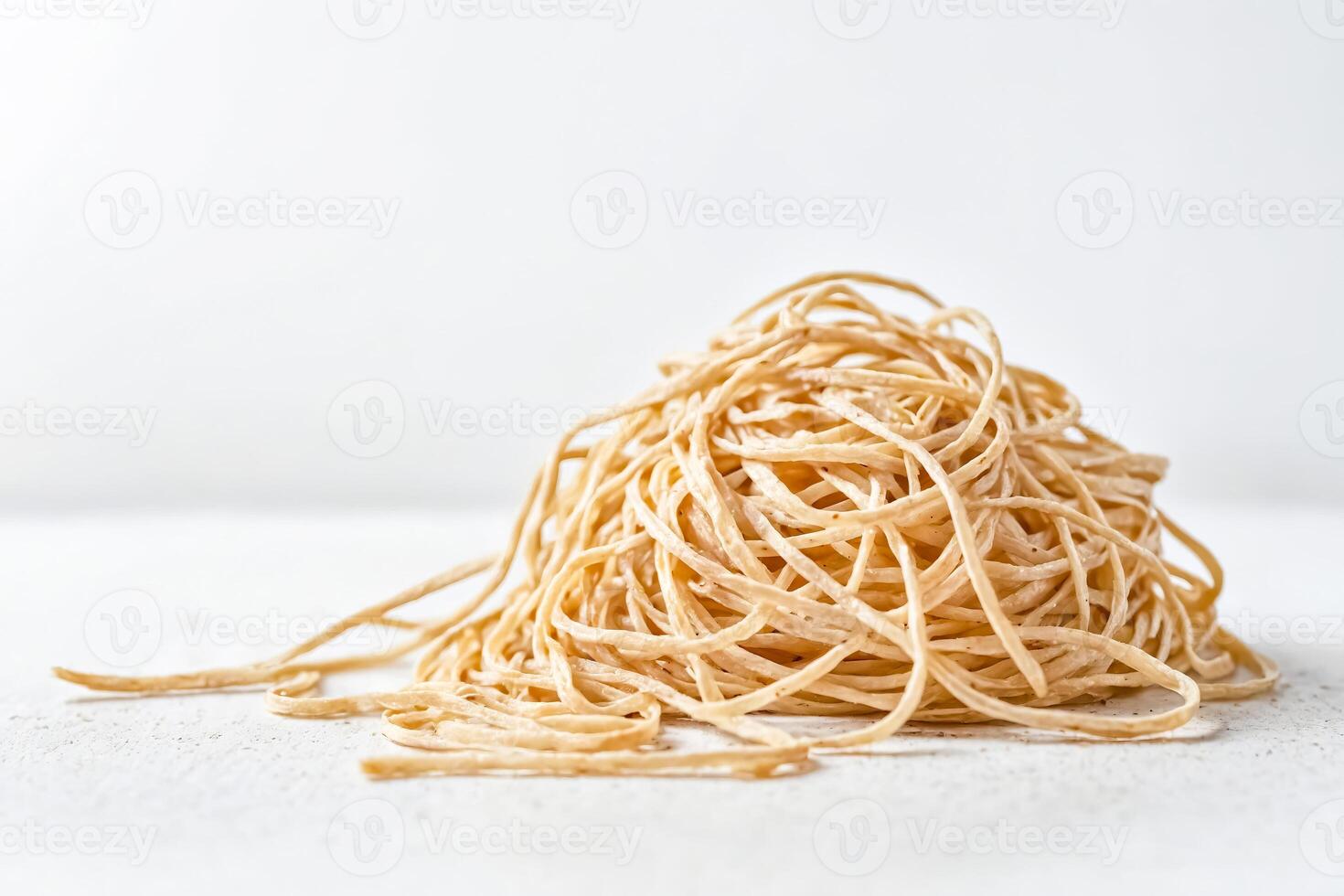Uncooked Spaghetti Noodles on White Background photo