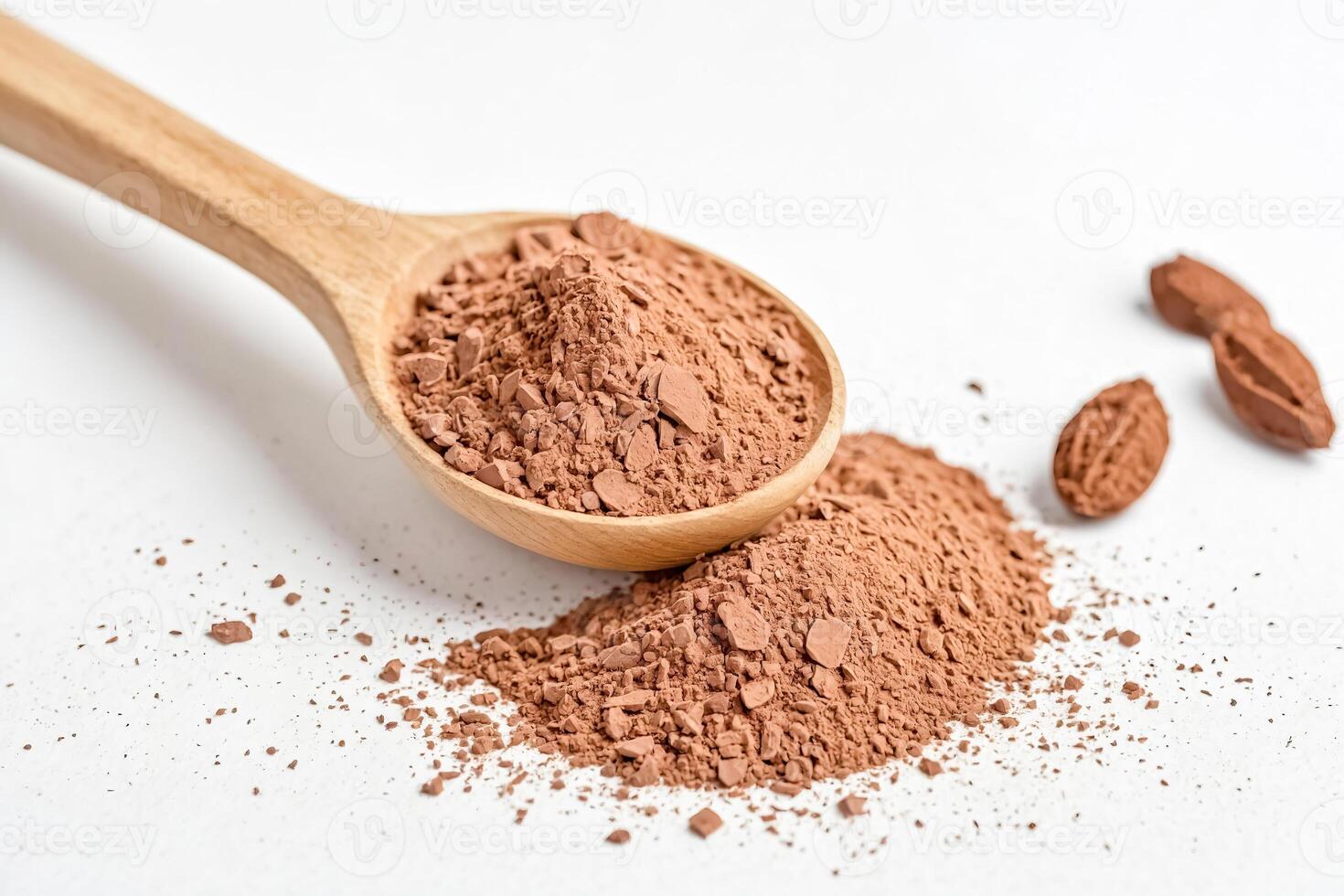 Cocoa powder in wooden spoon on white background photo