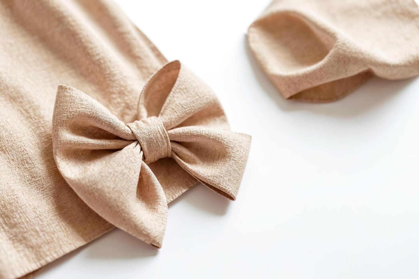 Beige Bow on Fabric Background photo