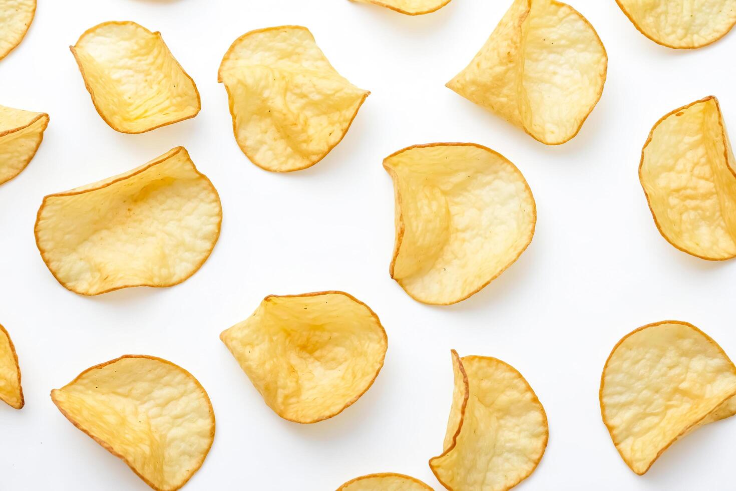 Crispy Potato Chips Scattered on White Background photo