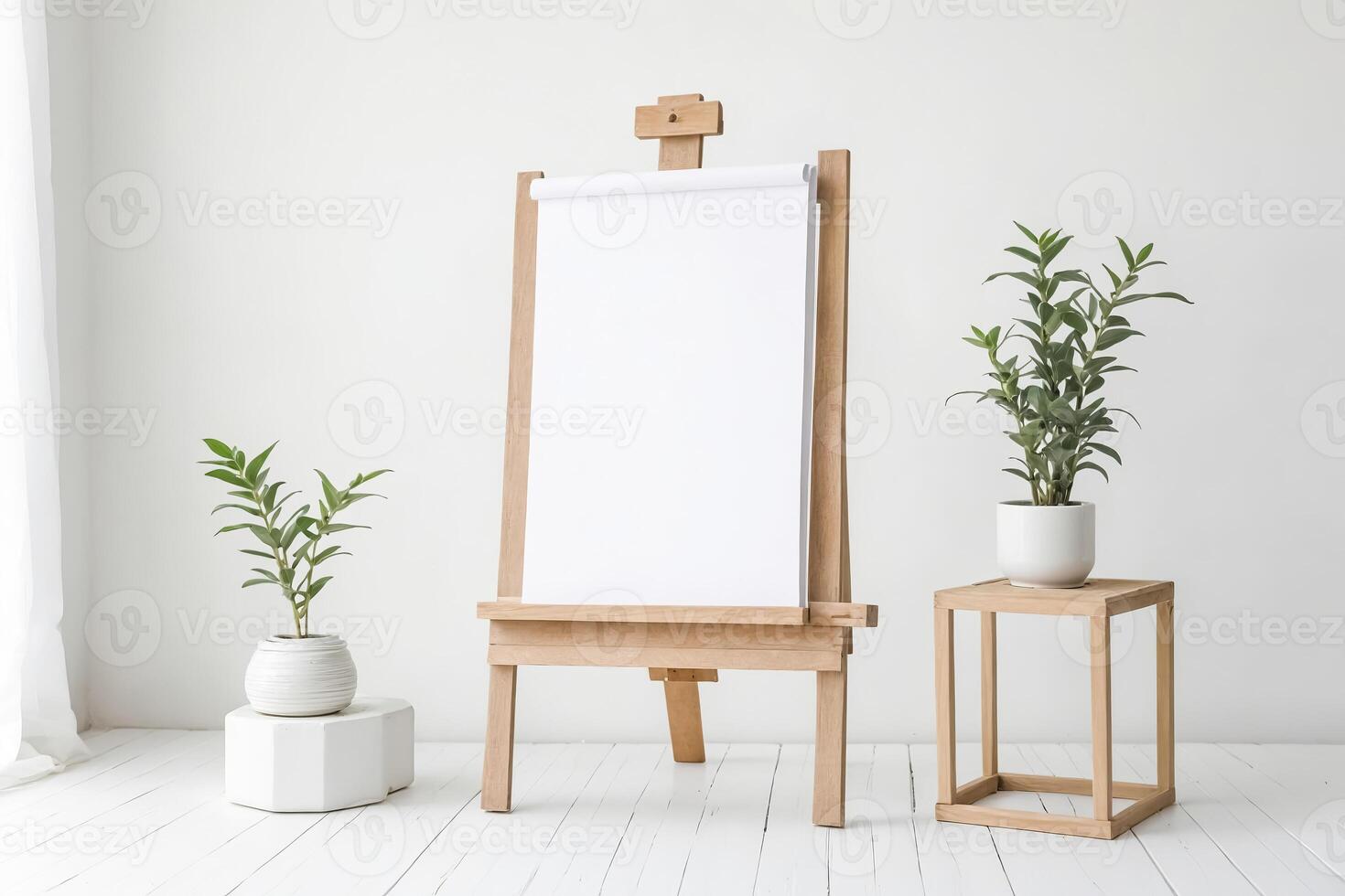 Wooden Easel with Blank Canvas and Plants in a White Room photo