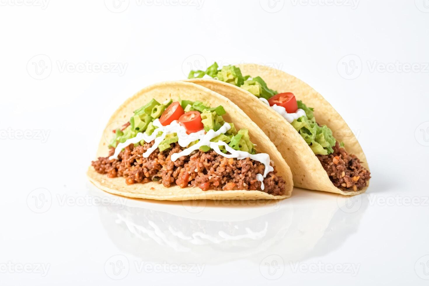 Ground beef tacos with avocado, lettuce and sour cream photo