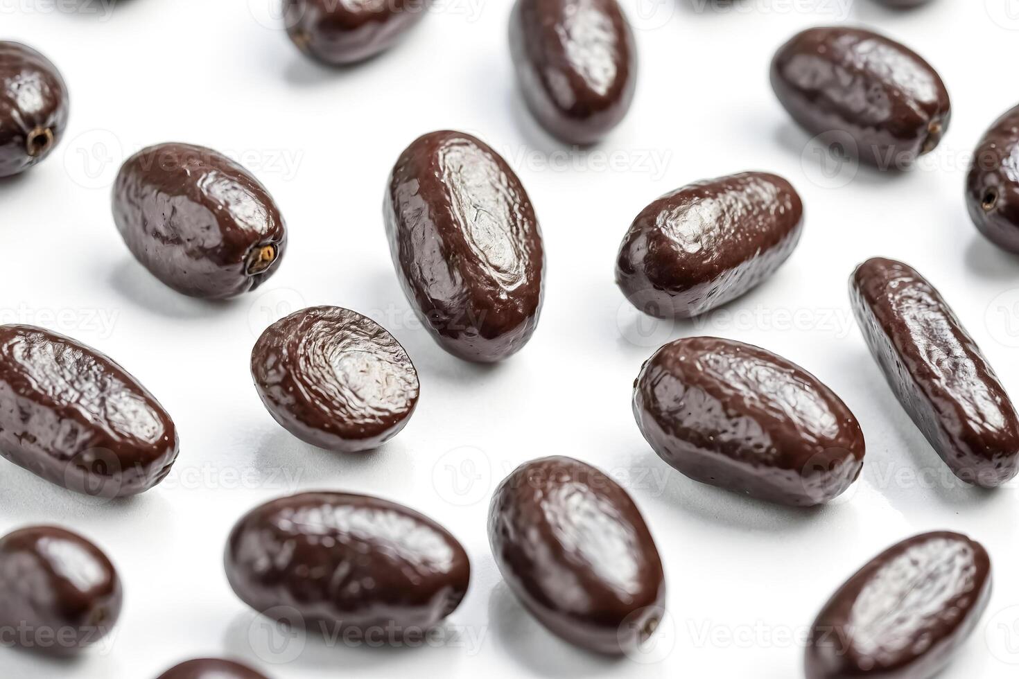 Close Up Of Dark Chocolate Covered Dates On A White Background photo