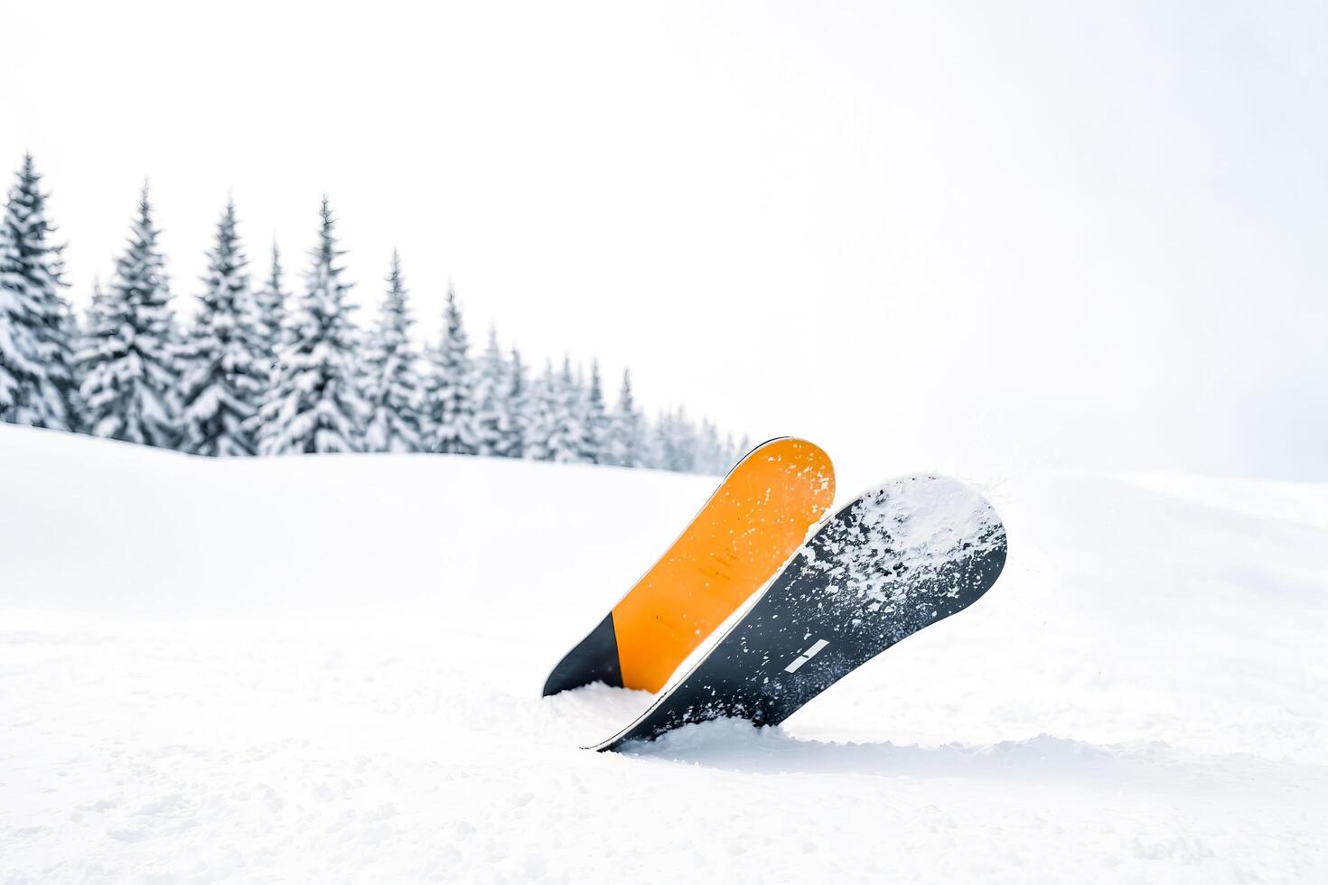 Snowboard stuck in the snow photo