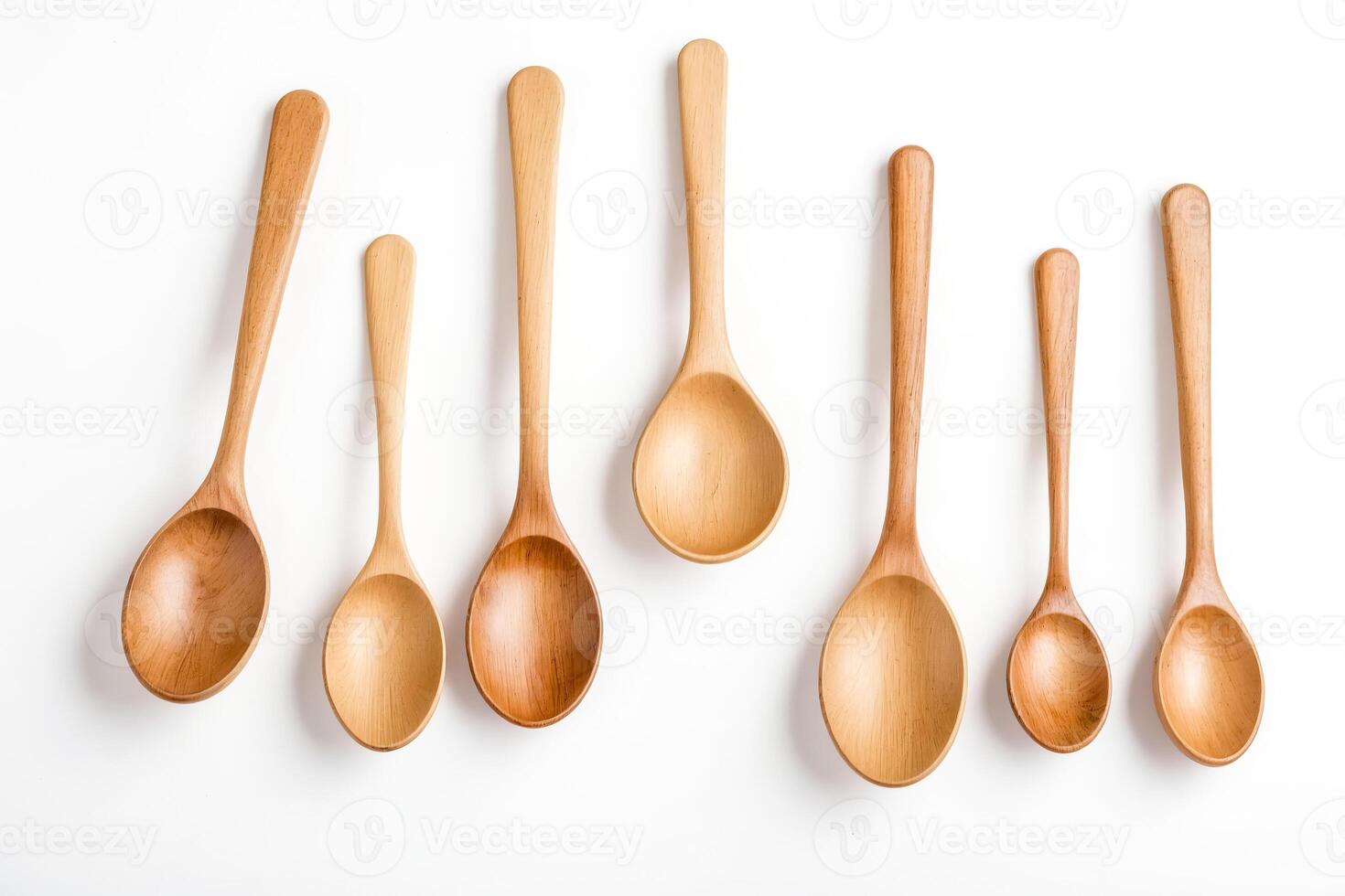 Wooden Spoons of Different Sizes on White Background photo