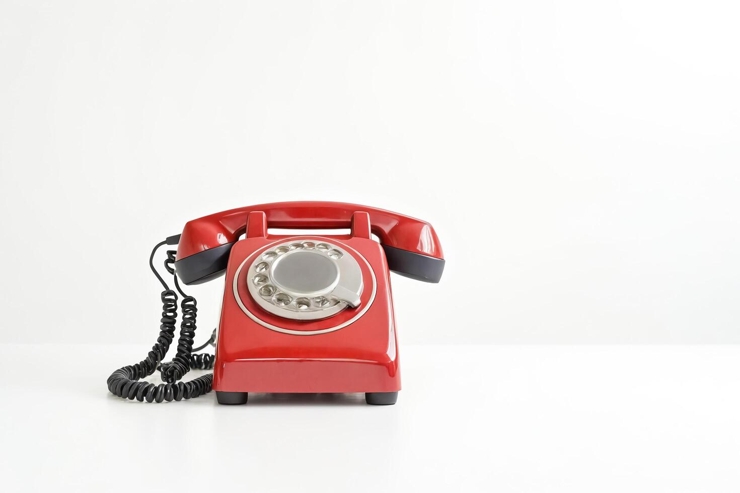 Red Vintage Rotary Phone on White Background photo