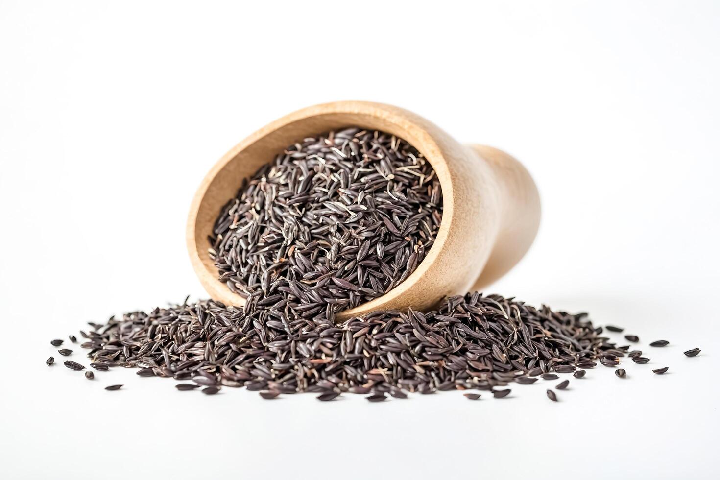 Black Rice Seeds in Wooden Bowl on White Background photo