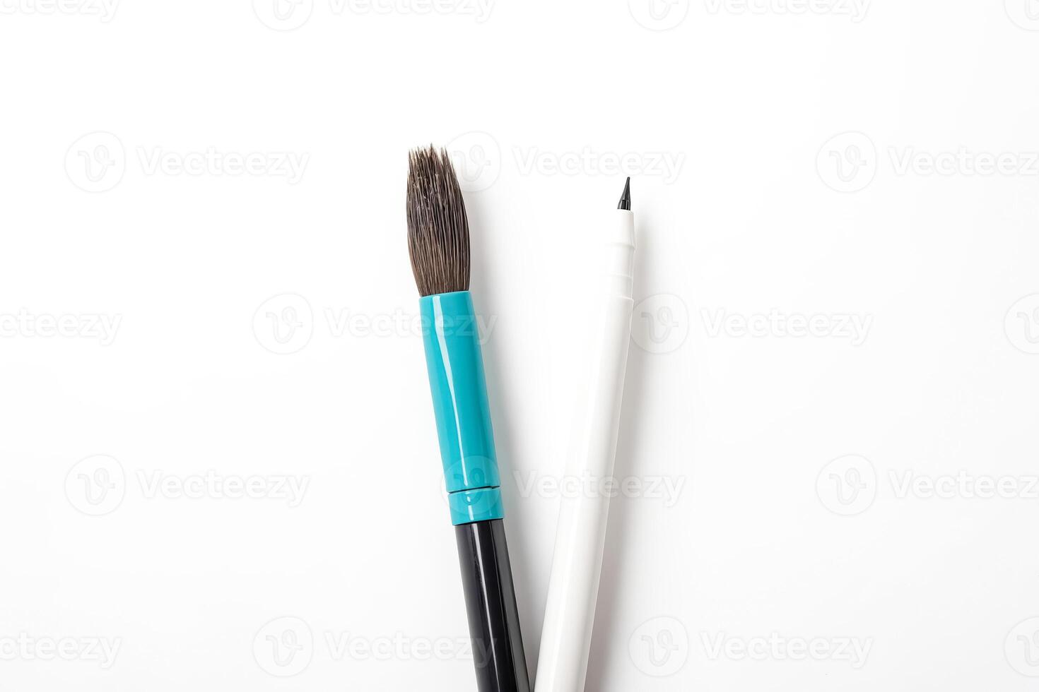 Close-up of Paintbrush and Pen on White Background photo