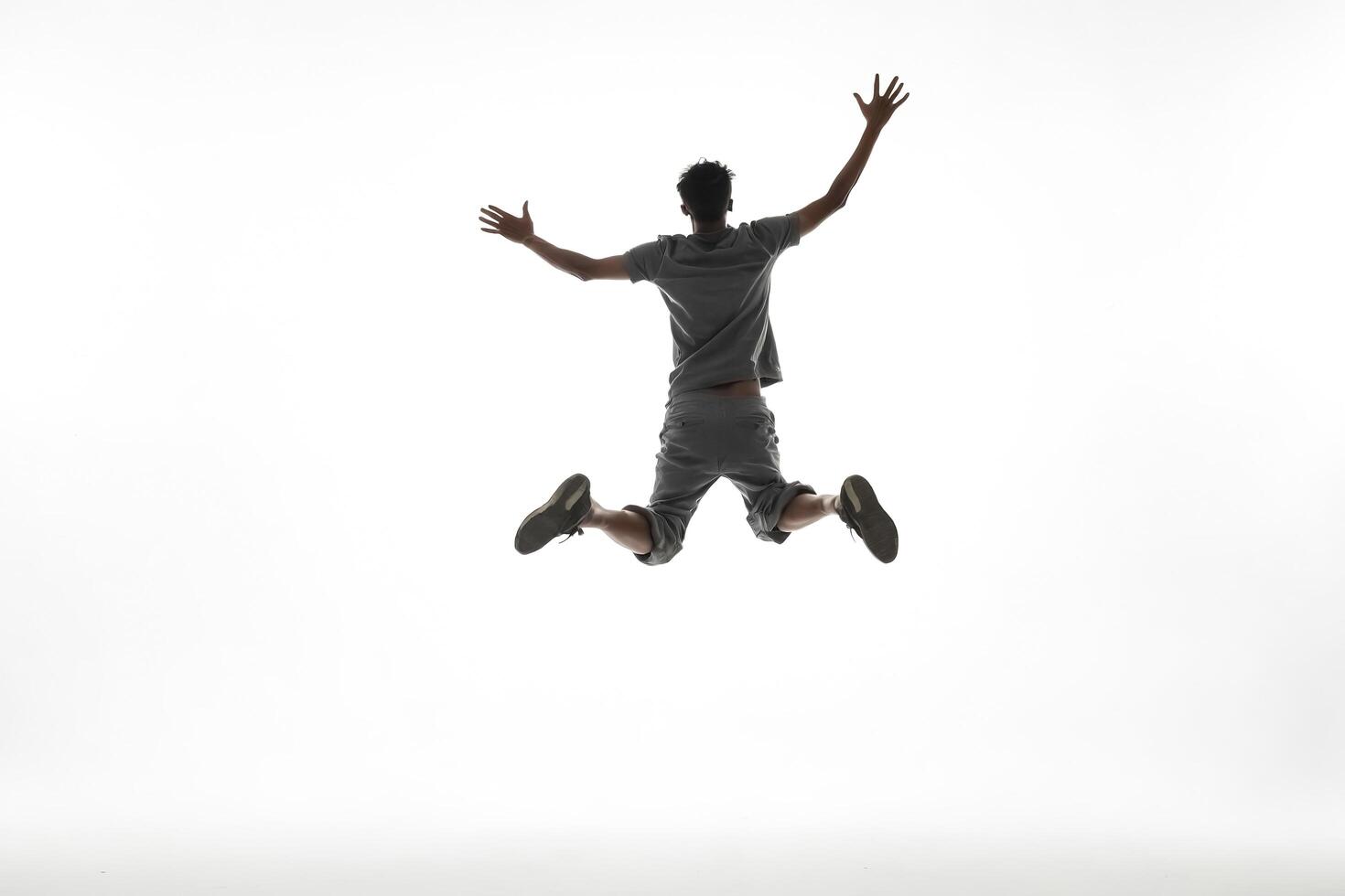 Silhouette of a man jumping in the air photo