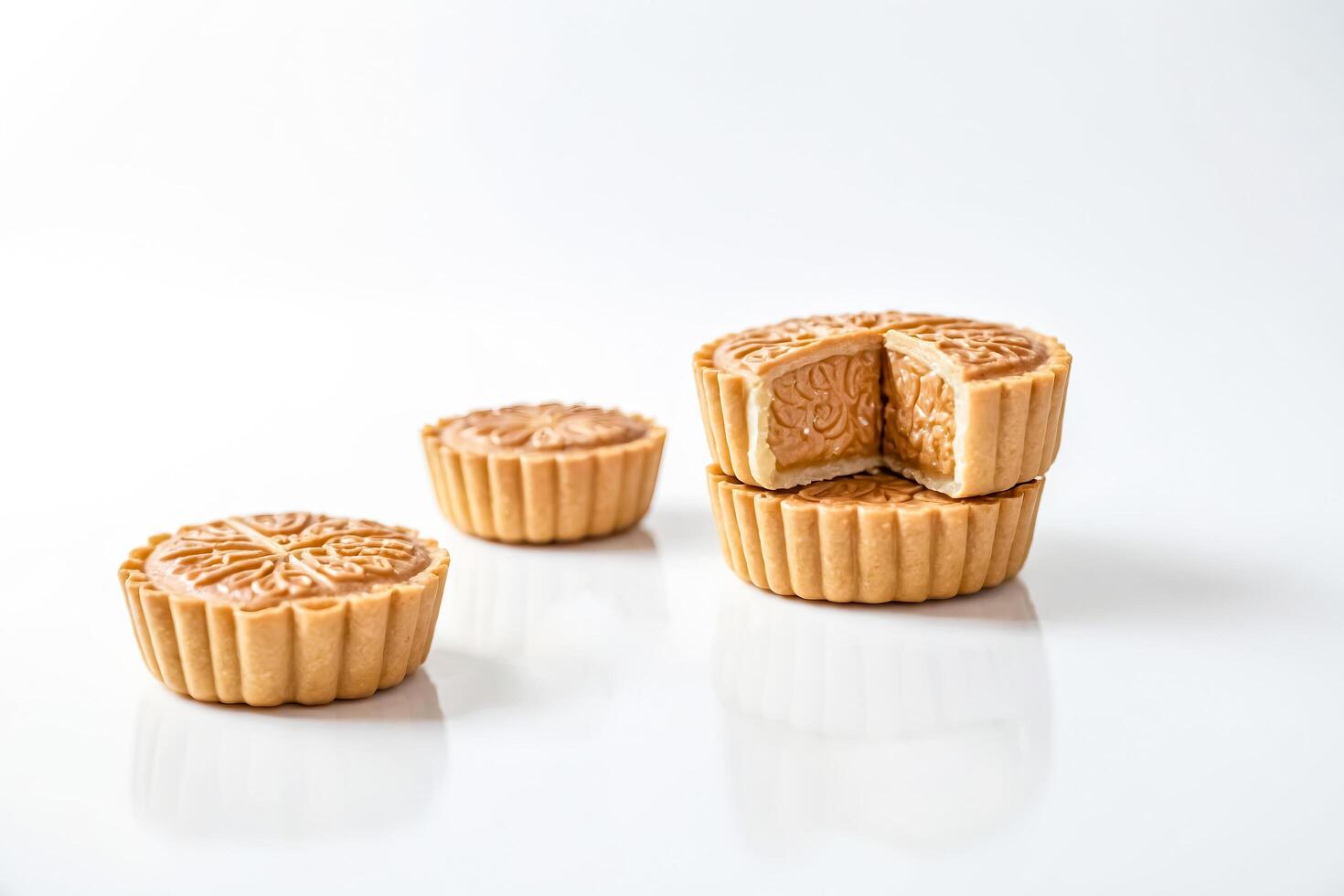 Close-up of Delicious Mooncakes with Caramel Filling on White Background photo
