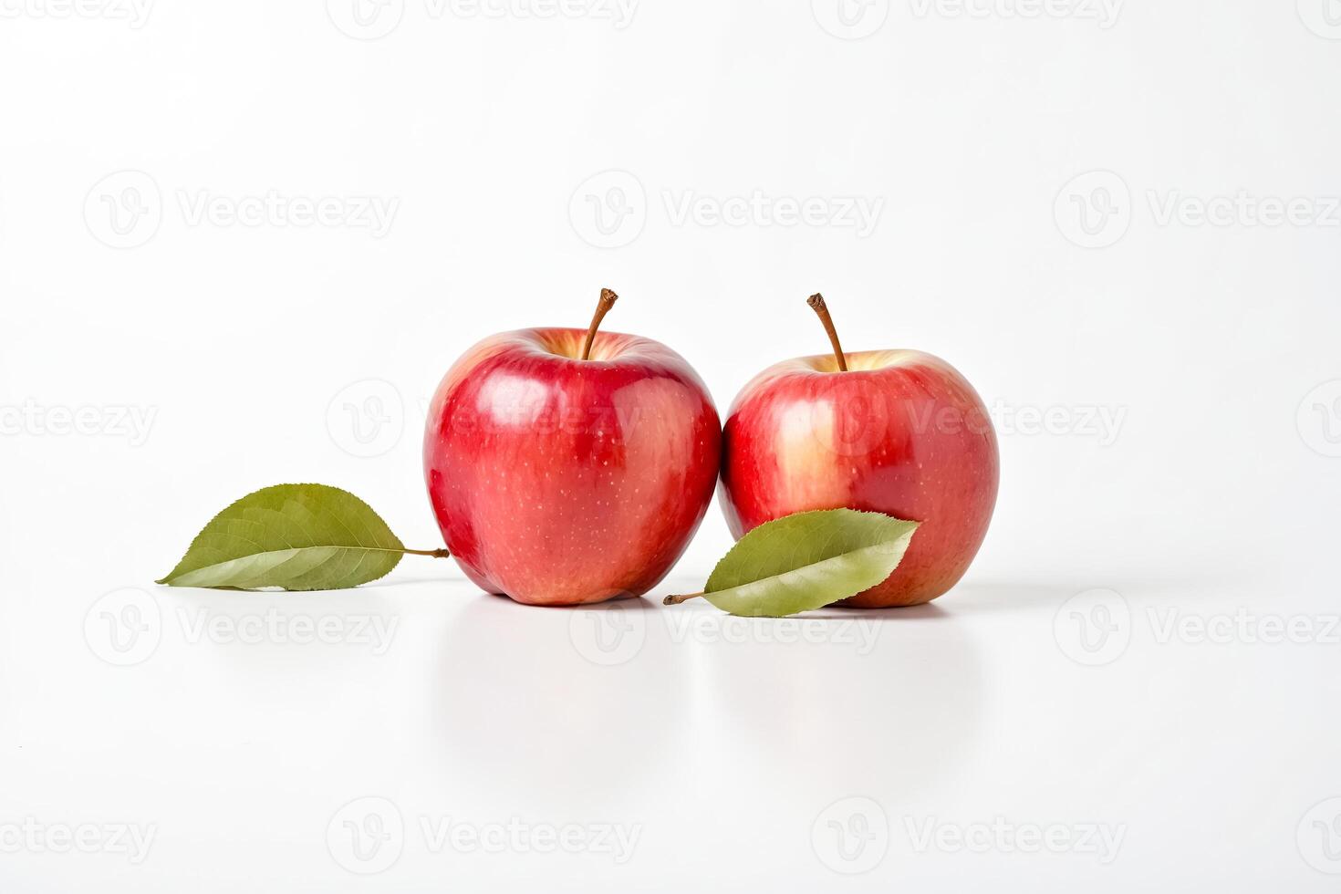 Two Red Apples with Green Leaves on White Background photo