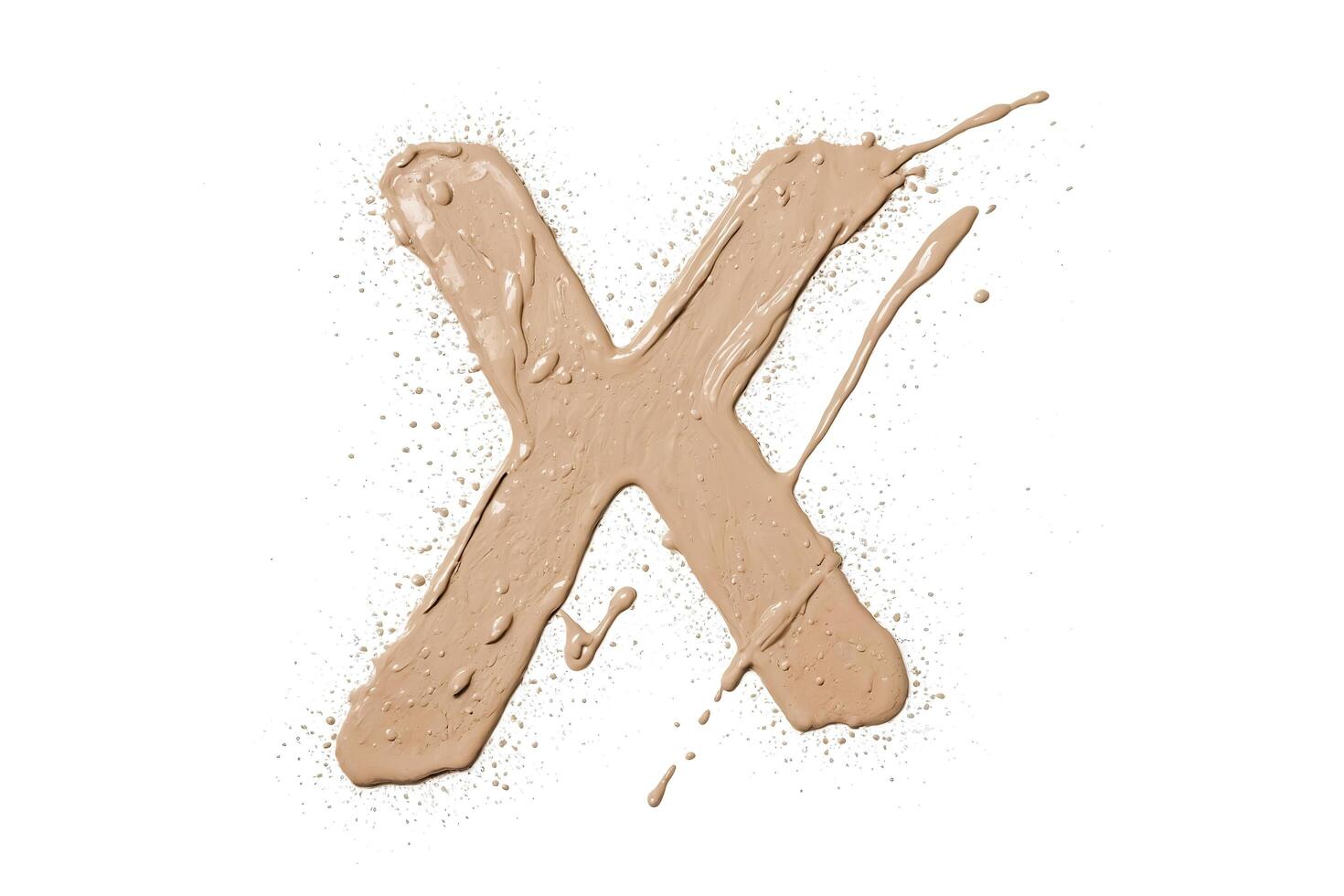 Splashes of Beige Makeup Forming the Letter X photo