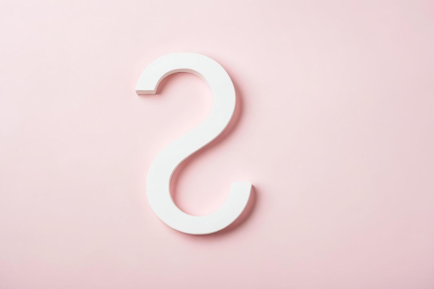 White S-shaped Object on Pink Background photo