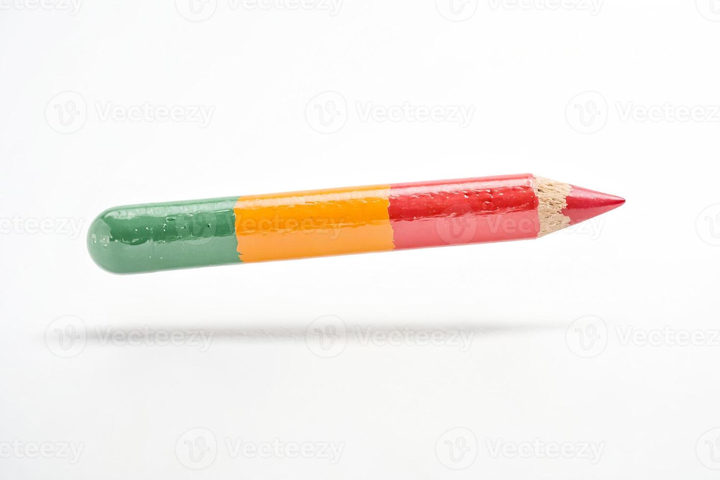 Green, Orange, and Red Pencil Floating in the Air photo