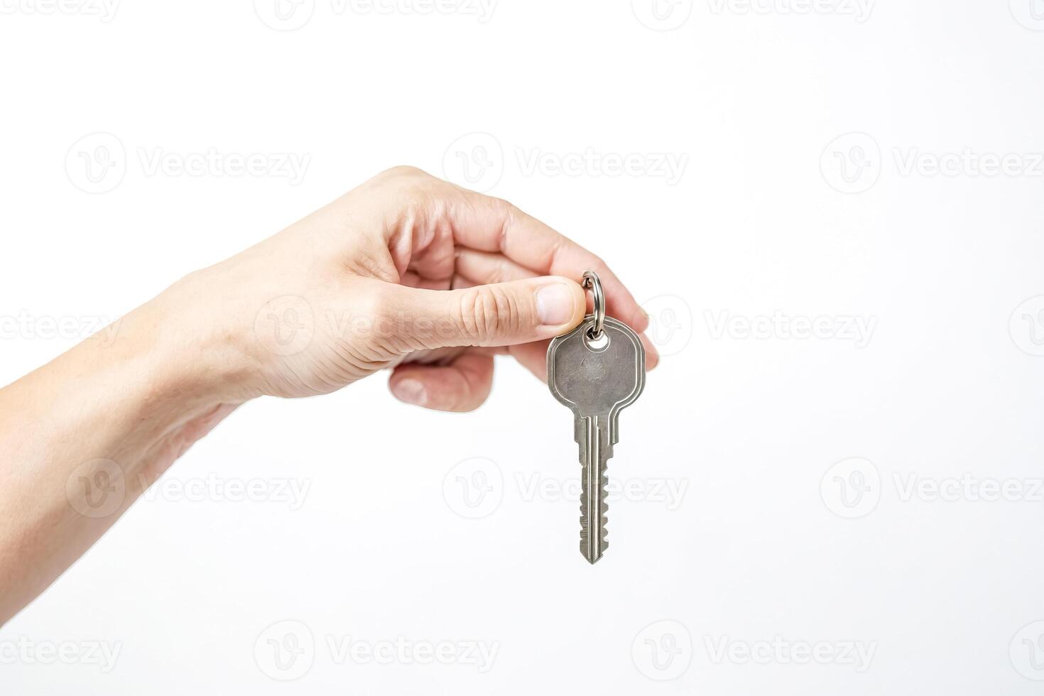 Hand Holding Key on White Background photo
