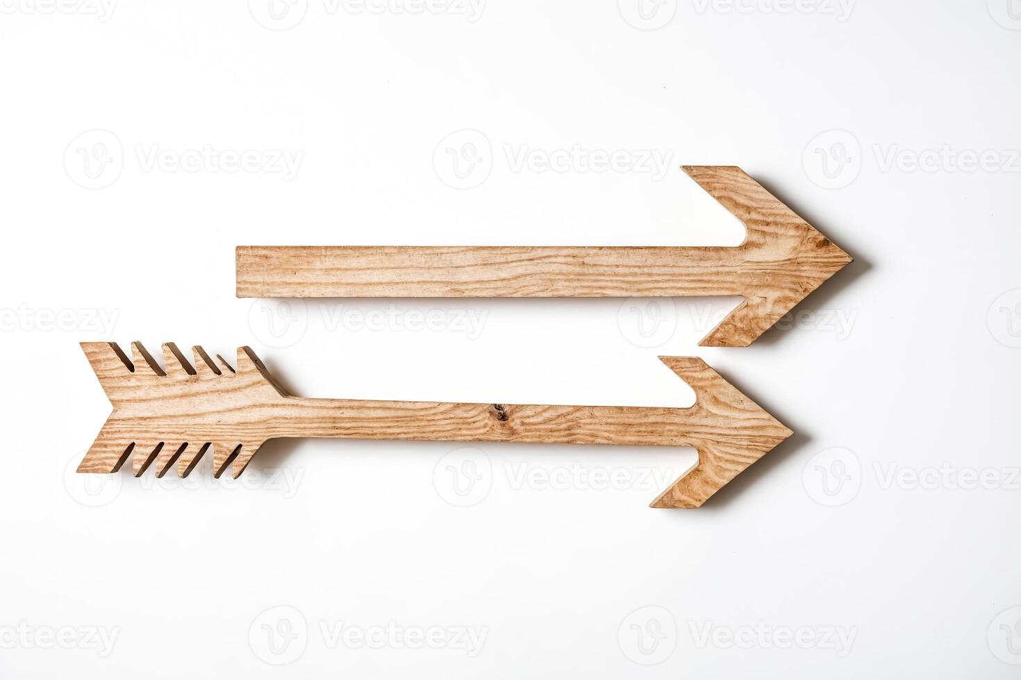 Two wooden arrows pointing right on white background photo