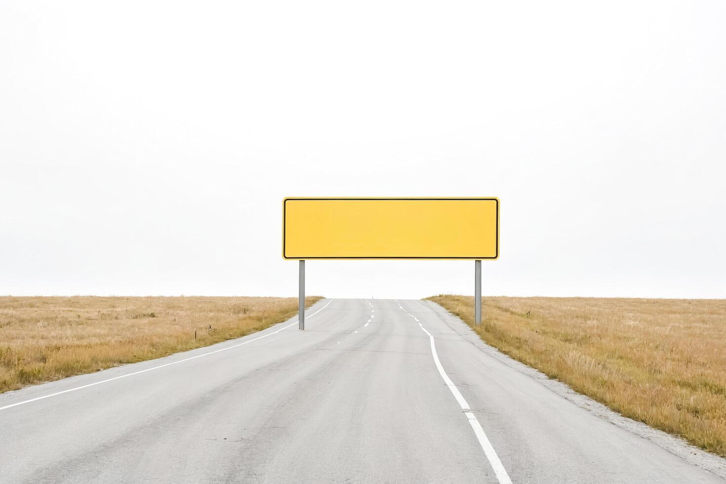 Blank Yellow Sign on an Empty Road photo