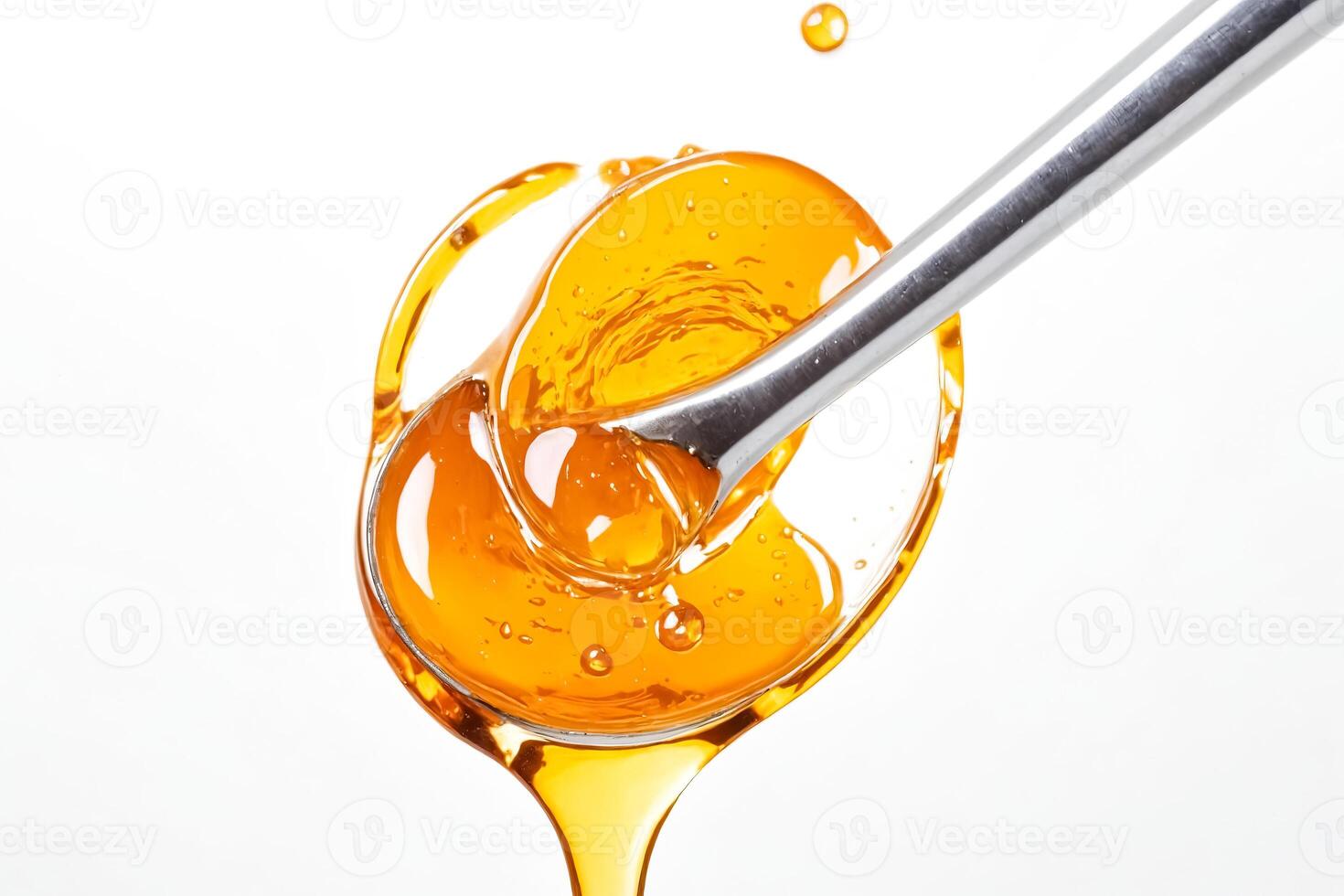 Honey Dripping from a Spoon photo