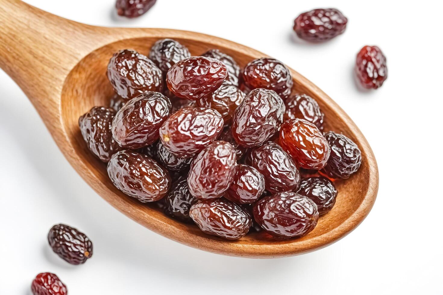 Closeup of Dried Dates in Wooden Spoon photo