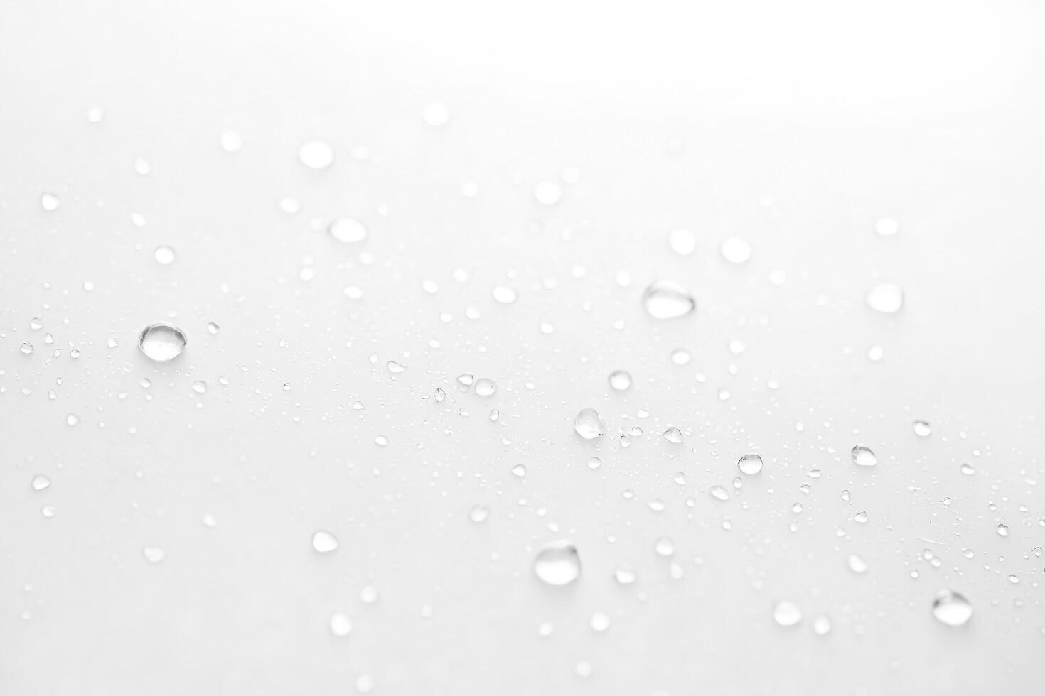Close Up of Water Droplets on White Surface photo