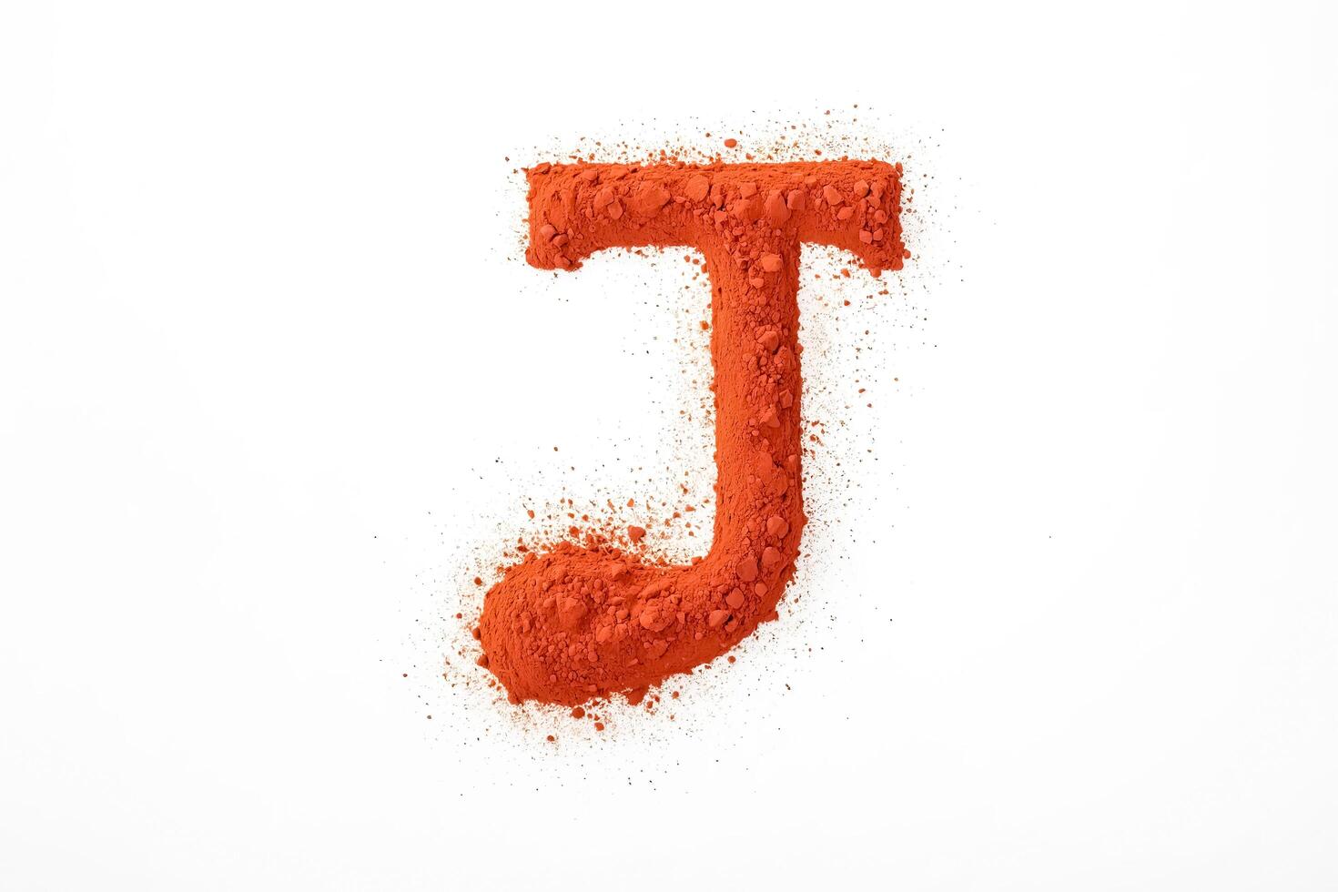 Letter J Made From Orange Powder on White Background photo