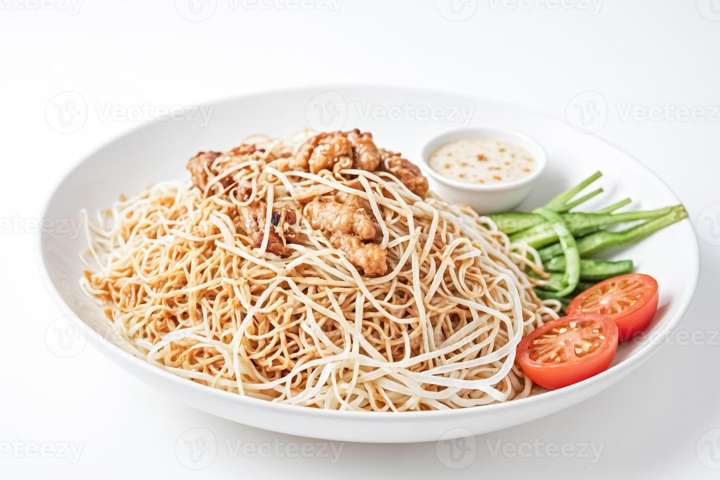A plate of noodles with chicken and vegetables photo