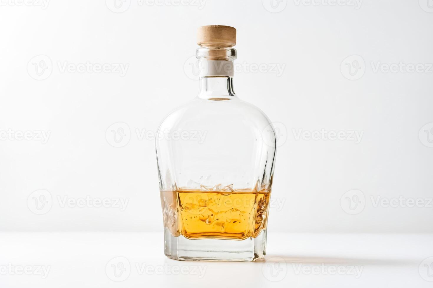 Glass bottle with cork stopper filled with amber liquid photo