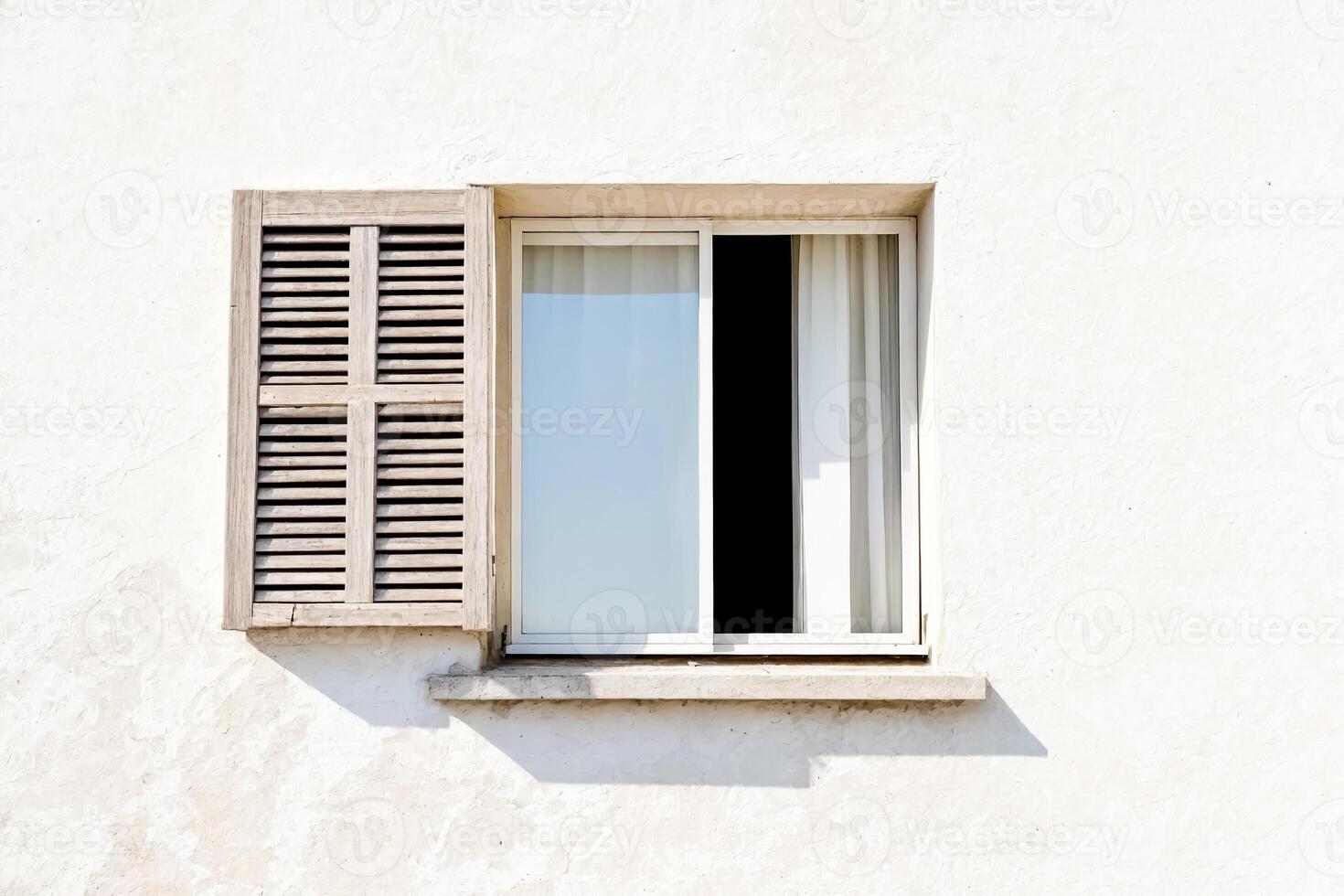 Wooden Shutter Window on White Wall photo