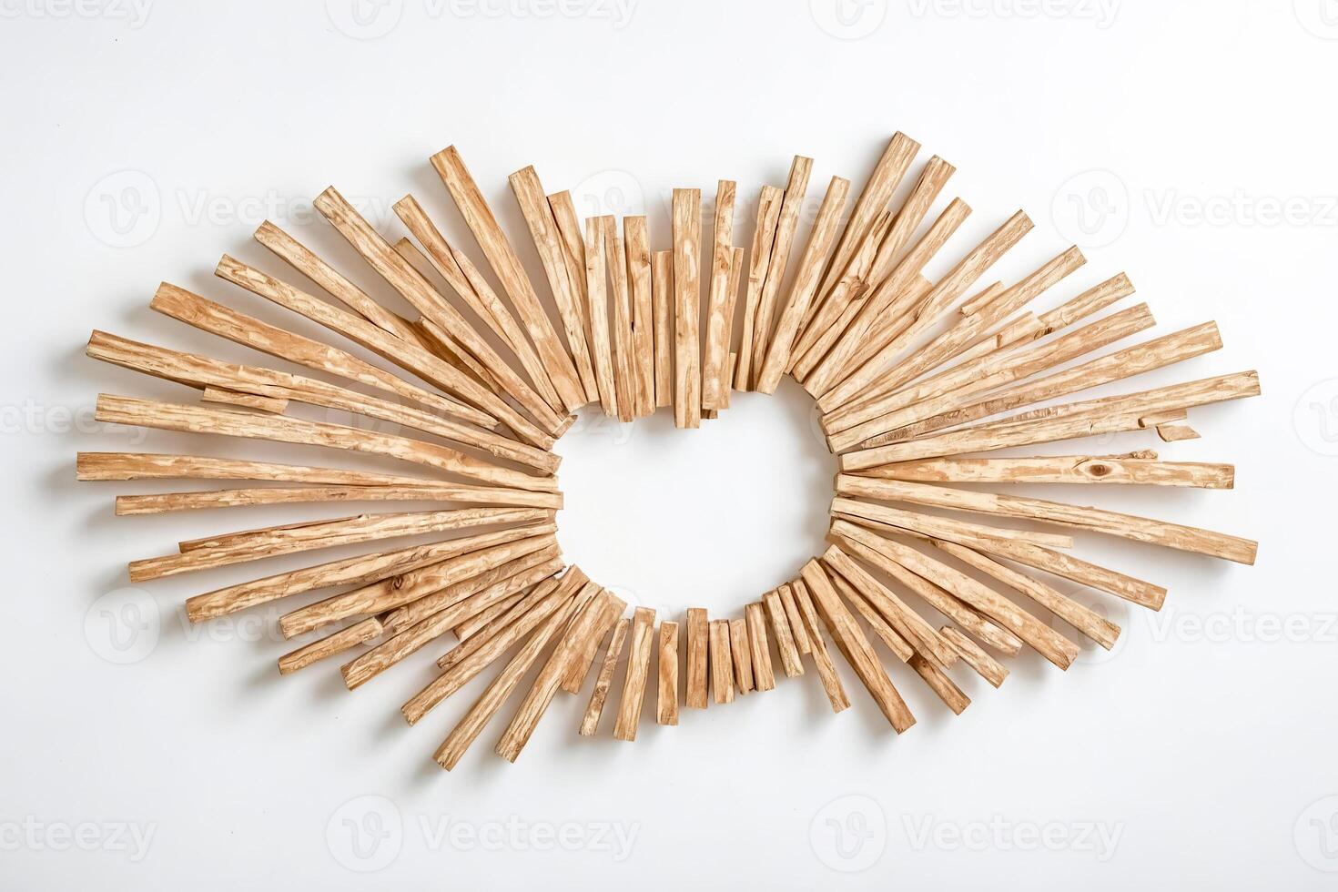 Wooden Sticks Arranged in a Circle with a Hole in the Middle photo