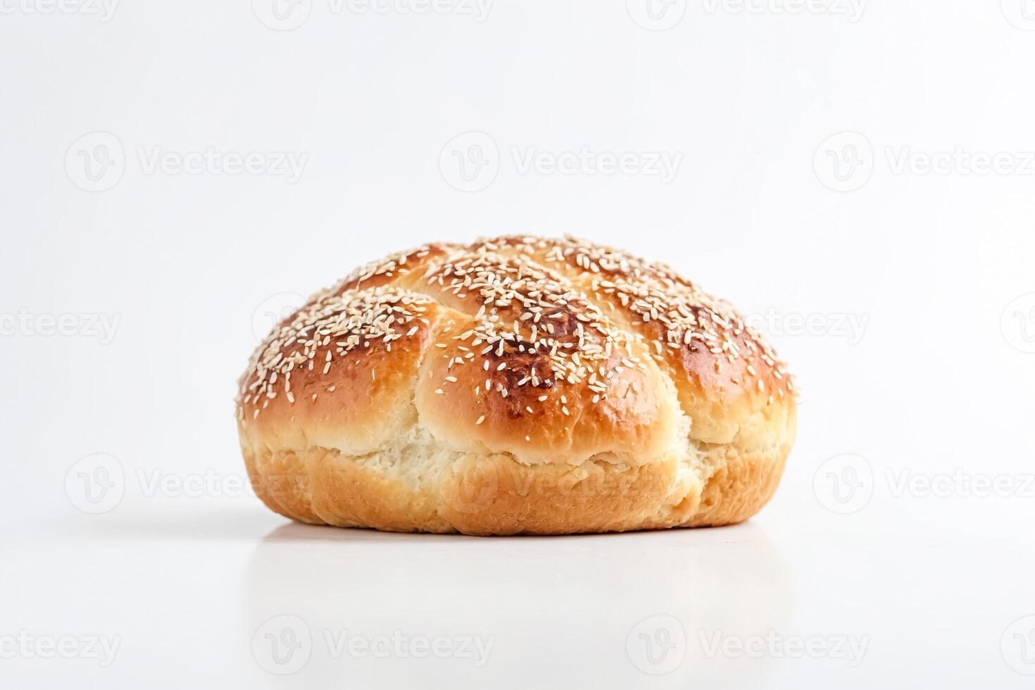 Close-up of a round, golden-brown sesame seed loaf of bread on a white background. photo