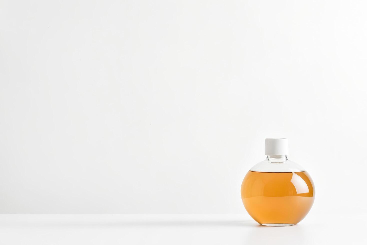 Amber Glass Bottle with White Lid on a White Background photo