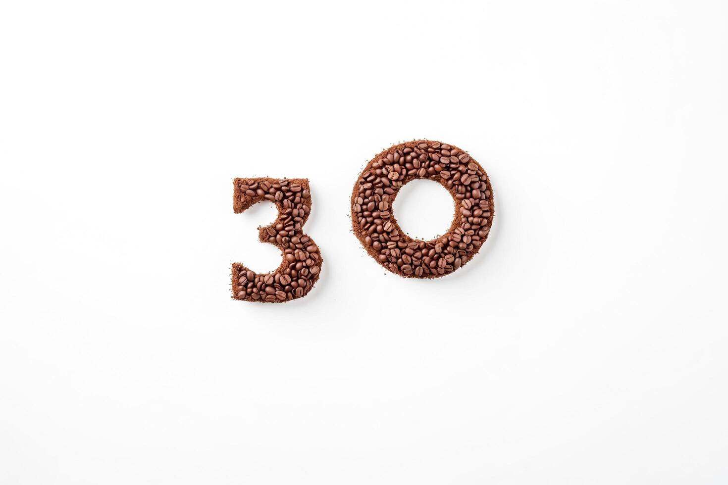 Number 30 made from coffee beans and grounds on white background photo