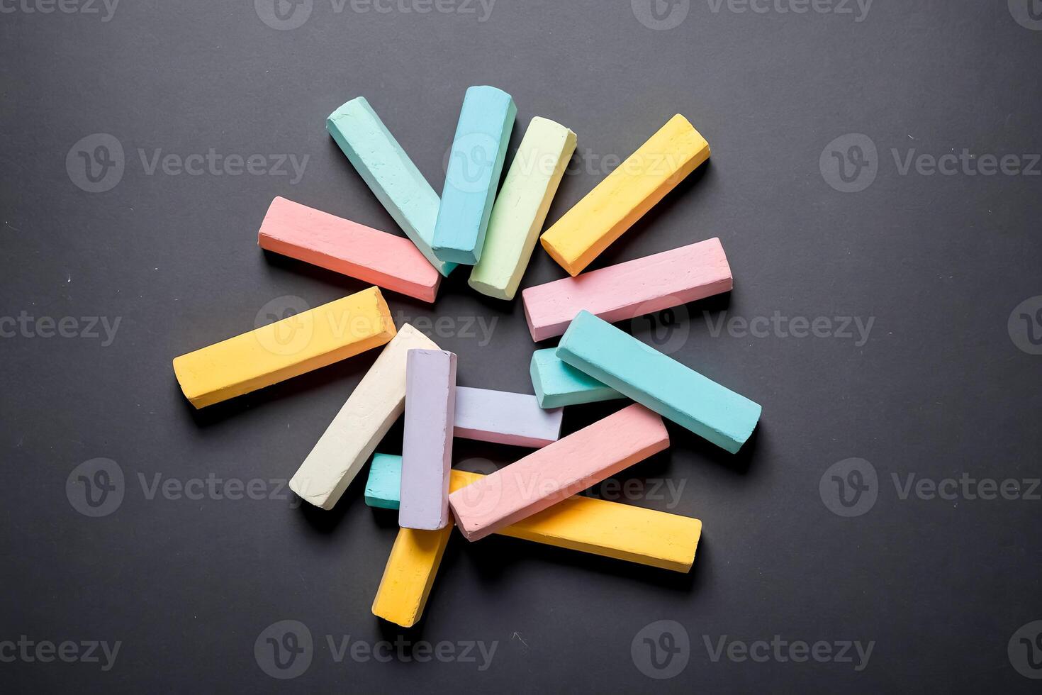 Colorful chalks on a black background photo