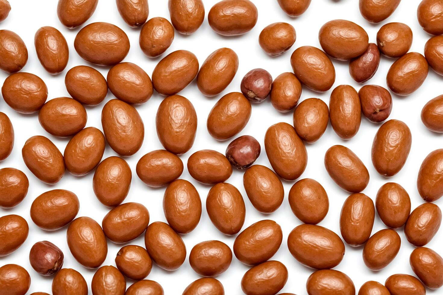 Brown oval shaped seeds on white background photo