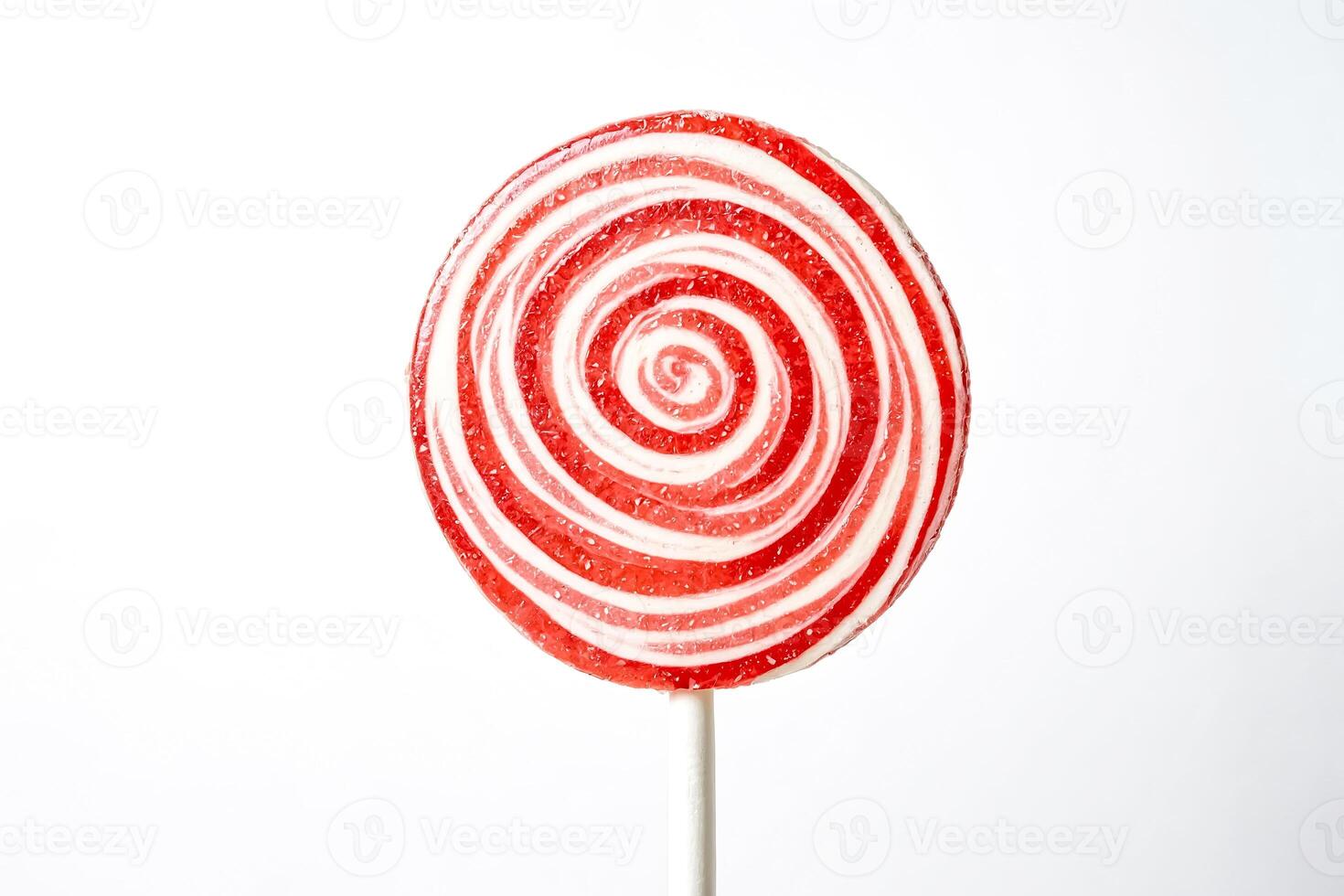 Red and White Swirled Lollipop on a White Background photo