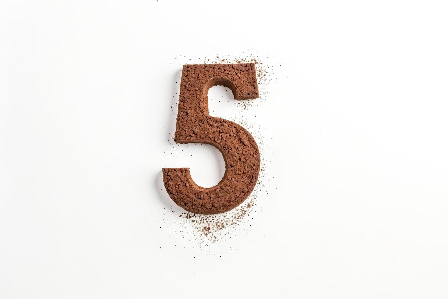 Number 5 Shaped From Cocoa Powder On White Background photo