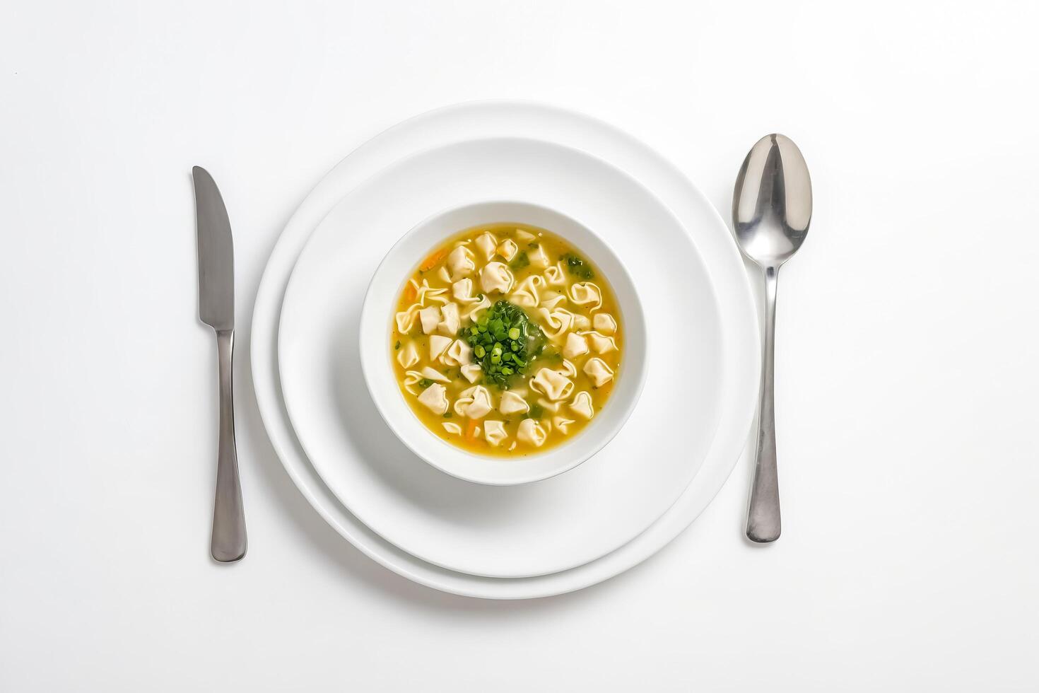 Top view of a bowl of soup with pasta and vegetables on a white background photo