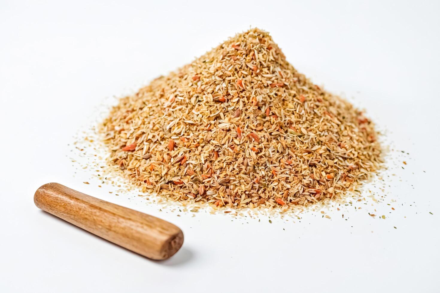 Pile of Dried Herbs and Spices with a Wooden Rolling Pin photo