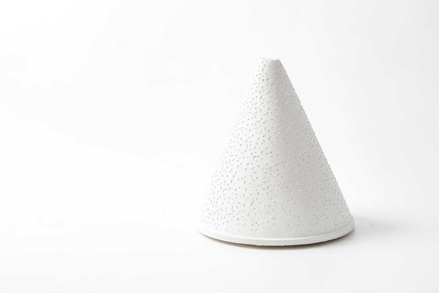 White Cone Shaped Object with a Textured Surface photo