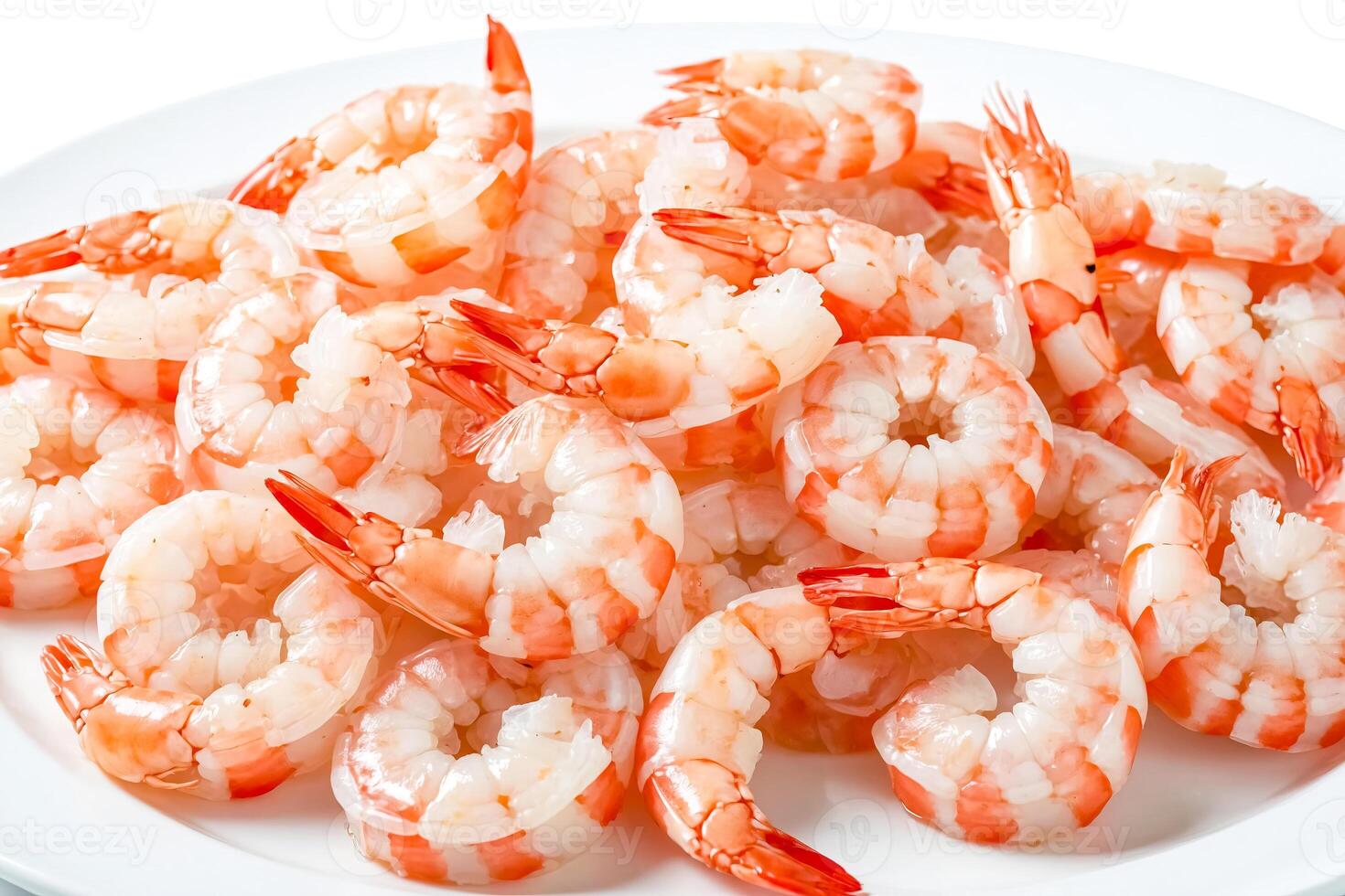 Close up of cooked shrimp on white plate photo