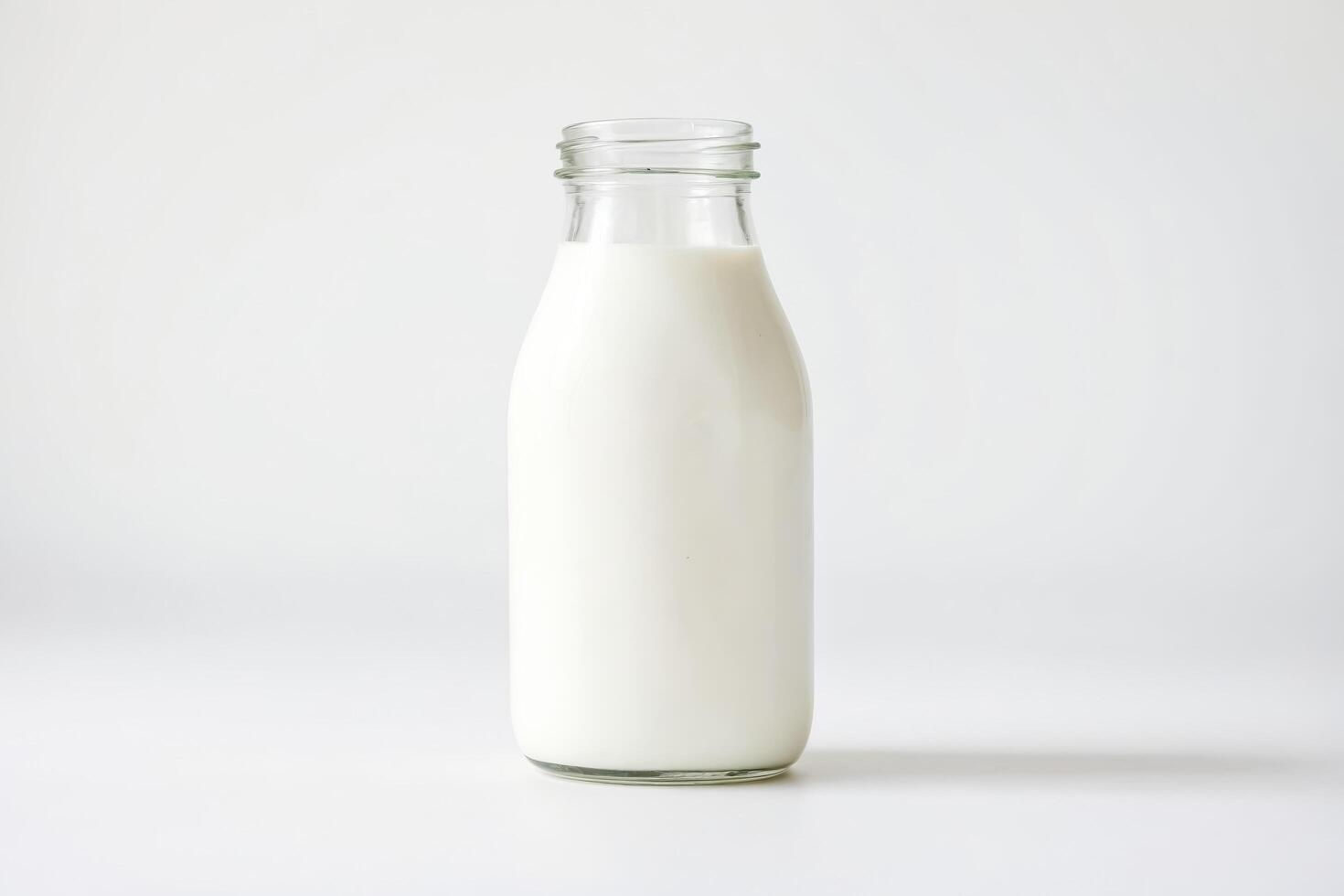 Glass bottle of milk on a white background photo