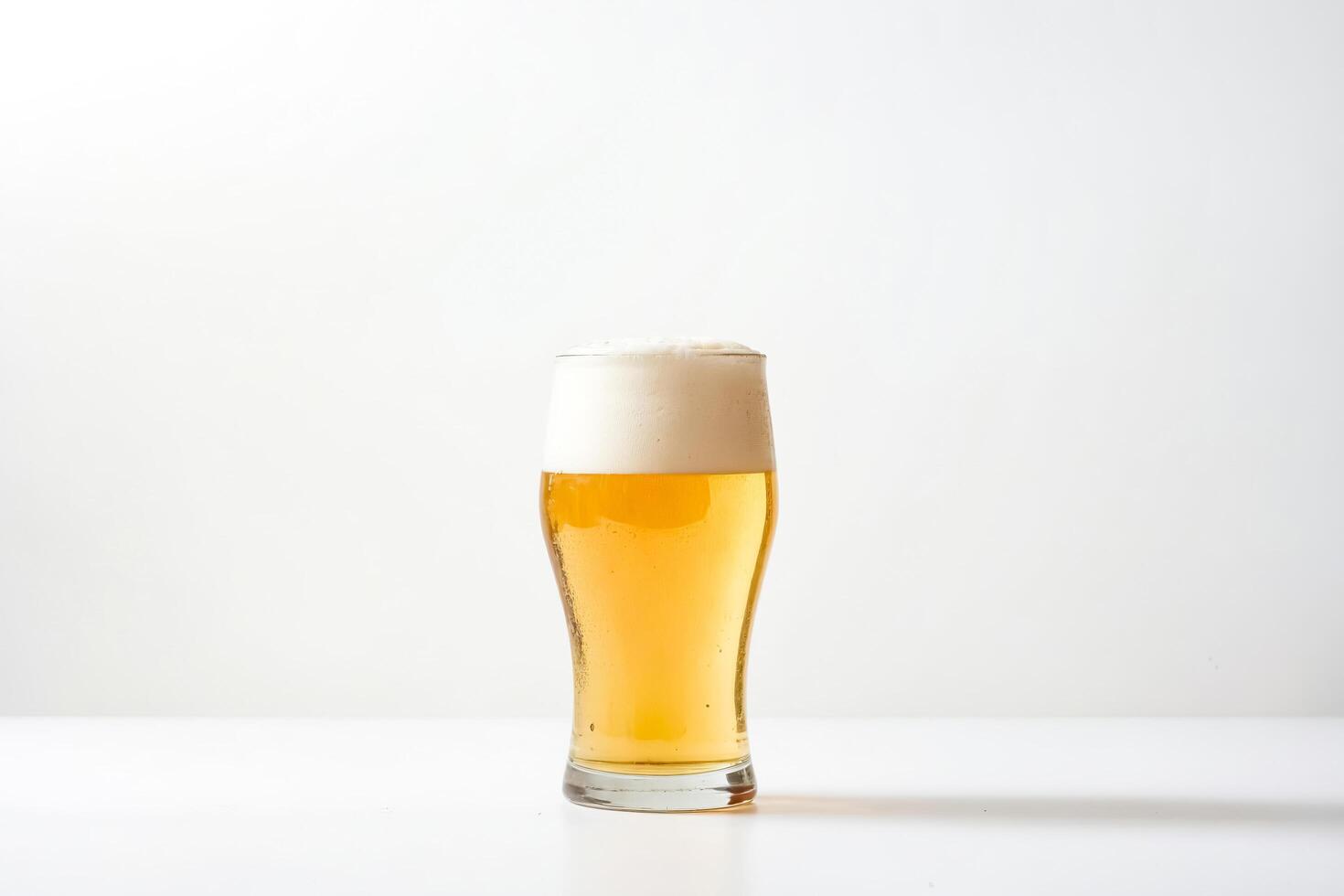 Glass of Beer with Head on White Background photo