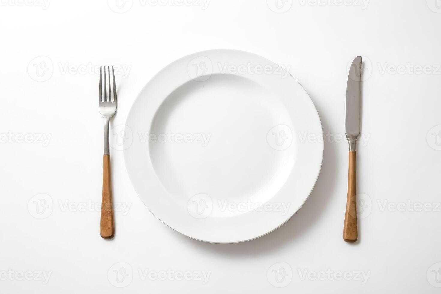 White Plate with Fork and Knife on White Background photo
